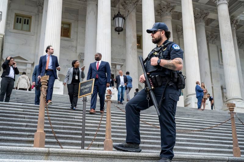 A U.S. Capitol Police officer stands watch as lawmakers leave the House of Representatives after voting on an interim spending bill to avoid a government shutdown next week, at the Capitol in Washington, Wednesday, Sept. 25, 2024. (AP Photo/J. Scott Applewhite)