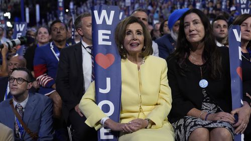 Rep. Nancy Pelosi, D-Calif., holds a sign as President Joe Biden speaks during the Democratic National Convention Monday, Aug. 19, 2024, in Chicago. (AP Photo/Paul Sancya)