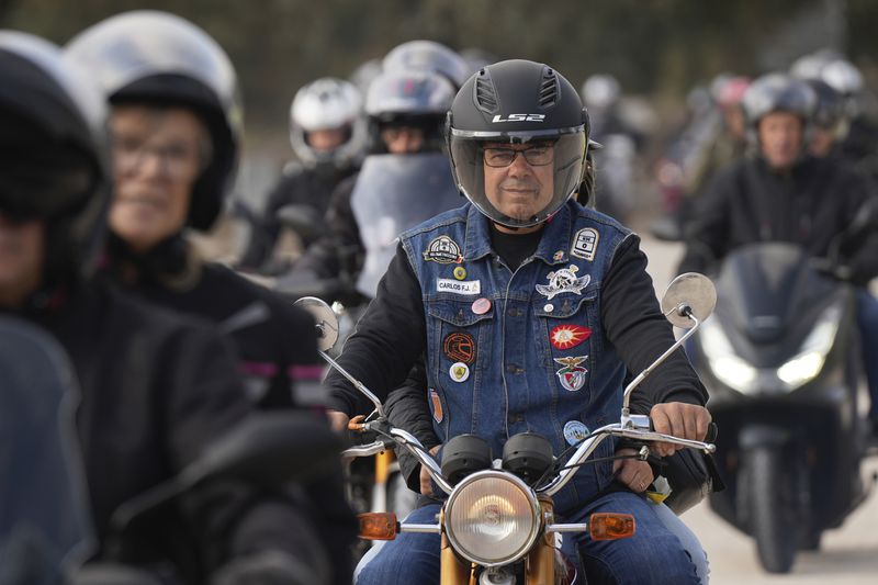 Motorcyclists arrive at the parking lots around the Roman Catholic holy shrine of Fatima to attend the IX Pilgrimage of the Blessing of Helmets that draws tens of thousands, in Fatima, Portugal, Sunday, Sept. 22, 2024. (AP Photo/Ana Brigida)