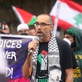 A Morehouse professor who chose to not attend commencement speaks during a Pro-Palestinian protest on Joseph E Lowery Blvd across the street from Morehouse College as President Joe Biden speaks during the 140th commencement ceremony, Sunday, May 19, 2024, in Atlanta. (Jason Getz / AJC)
