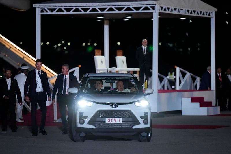 Pope Francis leaves the tarmac in a waiting car at Jackson's International Airport in Port Moresby, Papua New Guinea, Friday, Sept. 6, 2024. (AP Photo/Mark Baker)