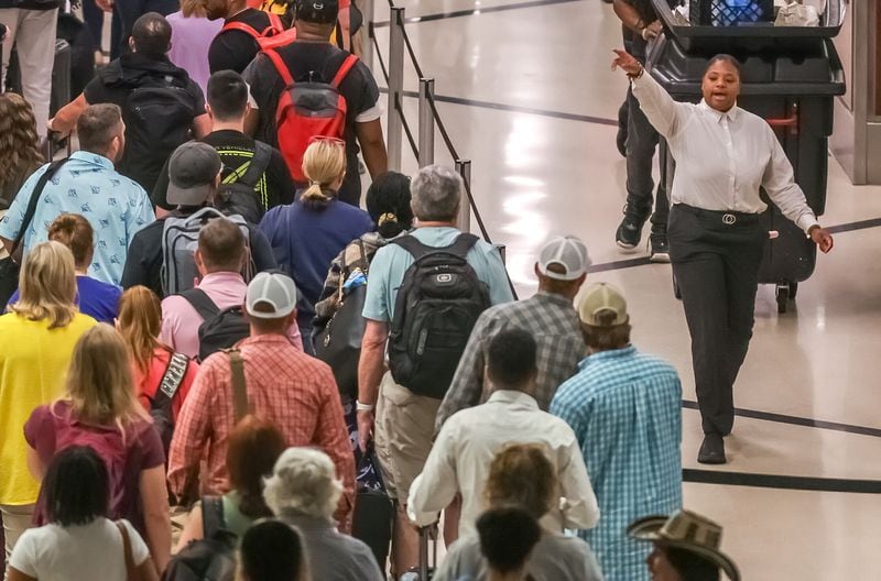 Travelers lined up at Hartsfield-Jackson International Airport on Friday, June 28, 2024, which is expected to be a peak day of the Fourth of July travel period. Credit: John Spink / jspink@ajc.com