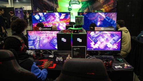 DreamHack attendees play Death Carnival, an arcade multiplayer shooter game, at the Georgia World Congress Center in 2019. (Steve Schaefer /AJC File 2020)