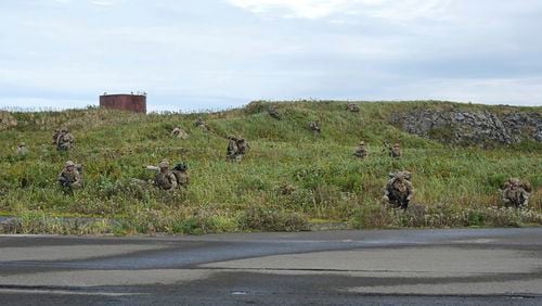 In this image released by the U.S. Army, U.S. Army soldiers assigned to 1st Battalion, 501st Parachute Infantry Regiment, 2nd Infantry Brigade Combat Team (Airborne), 11th Airborne Division, maneuver through the thick terrain of Shemya Island, Alaska, as part of a force projection operation to the remote island in the North Pacific Ocean, Sept. 13, 2024. (Spc. Brandon Vasquez/U.S. Army via AP)