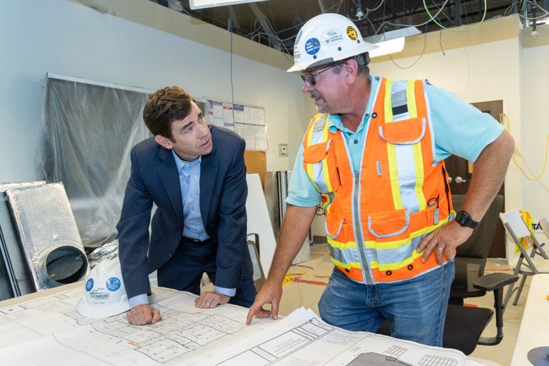 Cornerstone Christian Academy headmaster Colin Creel (left) goes over plans with Catamount Constructors Superintendant Joe Wall at the construction site of the schoolÕs new science labs. Cornerstone Christian Academy is the winner of the AJC's Top Workplace award in the category of small businesses. For story on the Top Workplace winners. PHIL SKINNER FOR THE ATLANTA JOURNAL-CONSTITUTION