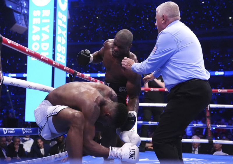 Anthony Joshua, left, and Daniel Dubois fight in the IBF World Heavyweight bout at Wembley Stadium, in London, Saturday, Sept. 21, 2024. (Bradley Collyer/PA via AP)