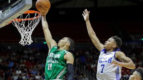 Boston Celtics forward Jayson Tatum (11) lays the ball in as Philadelphia 76ers guard Markelle Fultz (7) defends during the second half of an NBA summer league basketball game Monday, July 3, 2017, in Salt Lake City. (AP Photo/Rick Bowmer)