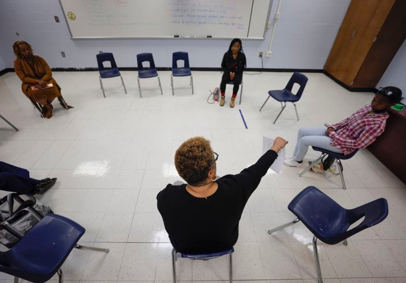 Jacqueline Beard-Cathey, the school community facilitator, leads students in a restorative circle session, where they are prompted to talk about conflicts in their lives and learn skills to resolve conflict, at Tri-Cities High School in East Point on Tuesday, March 29, 2022.   (Bob Andres / robert.andres@ajc.com)