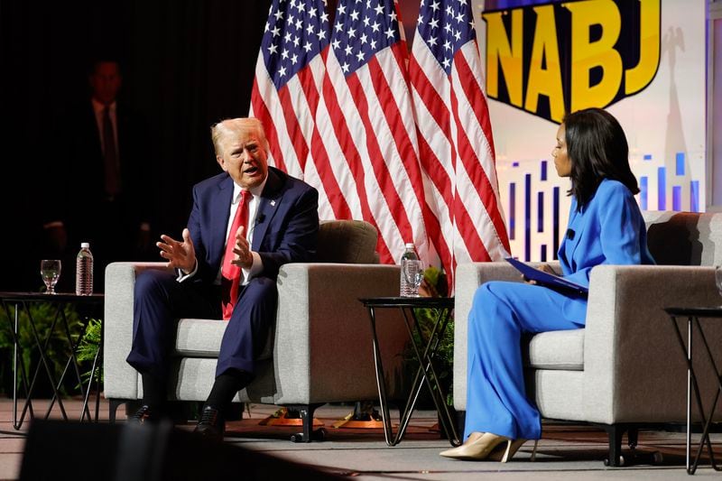 Former President Donald Trump answers questions as moderator Rachel Scott listens during a gathering of the National Association of Black Journalists in Chicago on Wednesday.