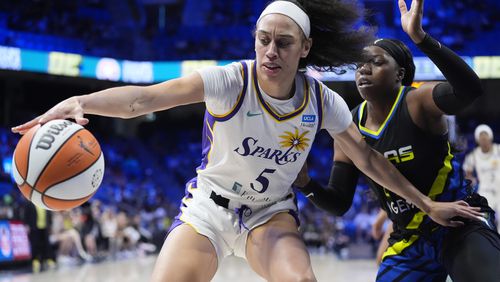 Los Angeles Sparks forward Dearica Hamby (5) tries to keep the ball away from Dallas Wings guard Arike Ogunbowale,right, during the second half of a WNBA basketball game in Arlington, Texas, Sunday, Aug. 25, 2024, (AP Photo/LM Otero)