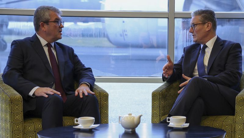 Britain's Prime Minister Keir Starmer, right, meets with the new U.K. Border Security Commander Martin Hewitt, ahead of his visit to Rome, at an airfield near London, Sunday, Sept. 15, 2024. (Phil Noble/Pool Photo via AP)