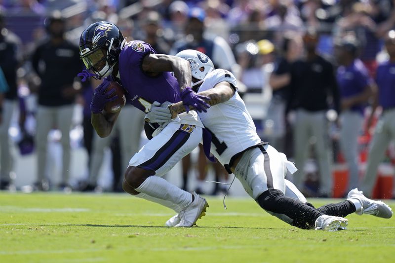 Las Vegas Raiders safety Marcus Epps (1) tackles Baltimore Ravens wide receiver Zay Flowers (4) during the first half of an NFL football game, Sunday, Sept. 15, 2024, in Baltimore. (AP Photo/Stephanie Scarbrough)