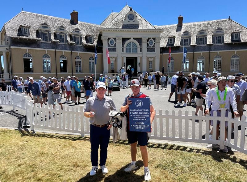 Frank Bensel, left, and his caddie and 14-year-old son, Hagen, pose in front of the clubhouse after Bensel turned up a pair of aces on the back-to-back holes during the second round of the U.S. Senior Open golf tournament at the Newport Country Club in Newport, R.I., Friday, June 28, 2024. (AP Photo/Jimmy Golen)