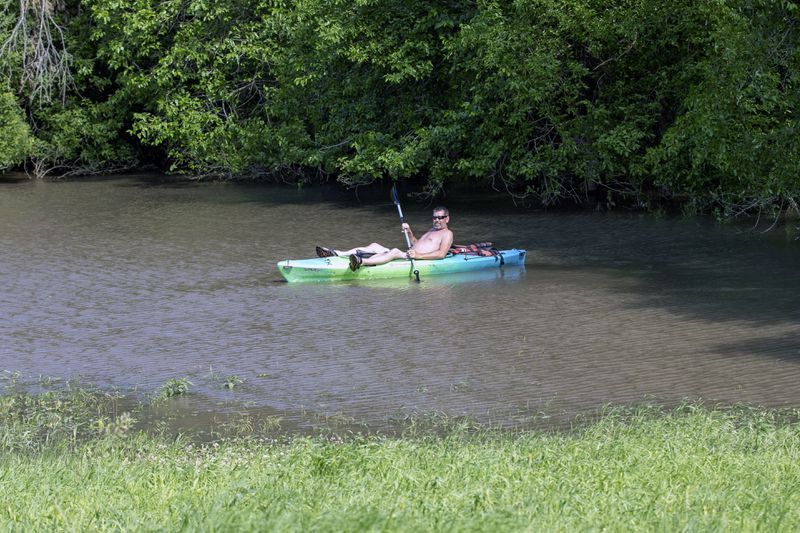 A resident kayaks through floodwaters caused by heavy rainfall, Saturday, June 22, 2024, in Canton, S.D. (AP Photo/Josh Jurgens)