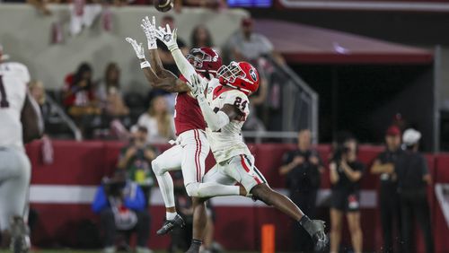 Georgia defensive back Malaki Starks (24) tips as pass against Alabama wide receiver Ryan Williams (2) and Williams eventually caught it after tipping the ball to himself during the second half at Bryant-Denny Stadium, Saturday, Sept. 28, 2024, in Tuscaloosa, Al. Alabama won 41-34. (Jason Getz / AJC)

