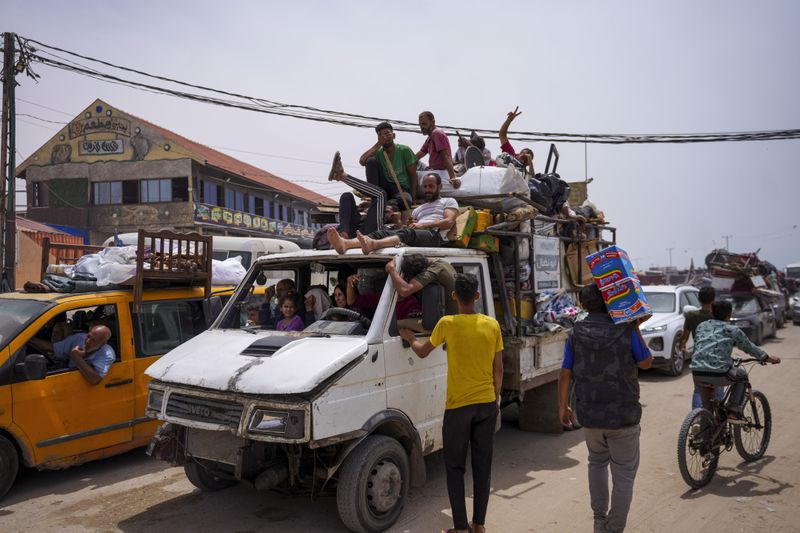 Palestinians fleeing from the southern Gaza city of Rafah during an Israeli ground and air offensive in the city on Tuesday, May 28, 2024. (AP Photo/Abdel Kreem Hana)
