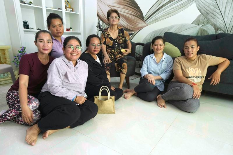 Chhim Sithar, second from right, president of the Labor Rights Supported Union of Khmer Employees of NagaWorld, sits near her mother, center, as she meets her staff members in her sister's home at the outskirts of Phnom Penh Cambodia, Monday, Sept. 16, 2024, after the prominent union leader freed from prison on Monday after serving time for her part in a strike against the country’s biggest casino. (AP Photo/Heng Sinith)