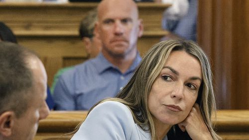 FILE — Karen Read listens to her attorney, Martin Weinberg, who was making motions to dismiss two charges against her, at Norfolk Superior Court, in Dedham, Mass., Friday, Aug. 9, 2024. (Greg Derr/The Patriot Ledger via AP, Pool, File)