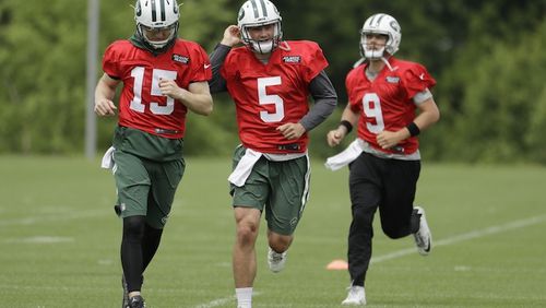New York Jets quarterbacks, from left, Josh McCown, Christian Hackenberg and Bryce Petty jog during the team's organized team activities at its NFL football training facility, Tuesday, May 23, 2017, in Florham Park, N.J. (AP Photo/Julio Cortez)