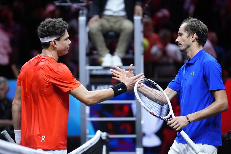 Team World's Ben Shelton, left, shakes hands with Team Europe's Daniil Medvedev after their singles tennis match on the third day of the Laver Cup tennis tournament, at the Uber arena in Berlin, Germany, Sunday, Sept. 22, 2024. (AP Photo/Ebrahim Noroozi)