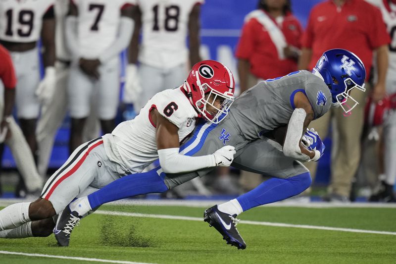 Kentucky wide receiver Dane Key (6) is tackled by Georgia defensive back Daylen Everette (6) during the first half of an NCAA college football game, Saturday, Sept. 14, 2024, in Lexington, Ky. (AP Photo/Darron Cummings)