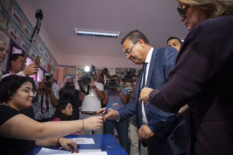 Tunisian President Presidential candidate Zouhair Maghzaoui prepares to cast his vote at a polling station during the presidential elections, in the capital Tunis, Tunisia, Sunday, Oct. 6, 2024. (AP Photo/Ons Abid)