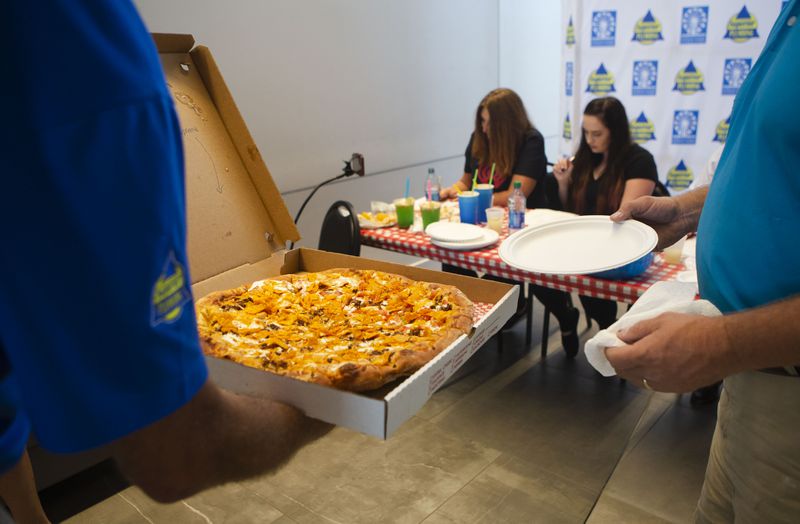 A Doritos pizza by Gillette's Pizza and Lemonade is carried to the judge's table during the Crazy Food Contest at the North Georgia State Fair at Jim R. Miller Park in Marietta, Georgia. Gillette's Pizza won the best taste category for their Doritos pizza. Sonny Fowler, a franchisee of Scoville Hot Chicken, won the most creative category for his chicken and waffle taco. CHRISTINA MATACOTTA FOR THE ATLANTA JOURNAL-CONSTITUTION. 