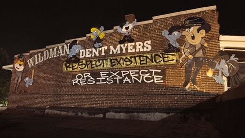Indecline, a group of artists/activists painted "Antifa Smurfs" on a storefront in downtown Kennesaw where the controversial Wildman’s Civil War Surplus store is located. (Courtesy of Indecline)