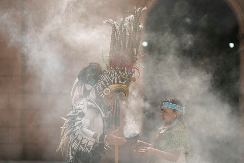 Mexica dancers burn incense during a ceremony commemorating the 503rd anniversary of the fall of the Aztec empire's capital, Tenochtitlan, in Mexico City, Tuesday, Aug. 13, 2024. (AP Photo/Eduardo Verdugo)