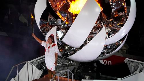 FILE - Naomi Osaka lights the Olympic cauldron during the opening ceremony at the Olympic Stadium at the 2020 Summer Olympics, July 23, 2021, in Tokyo. (AP Photo/Morry Gash)