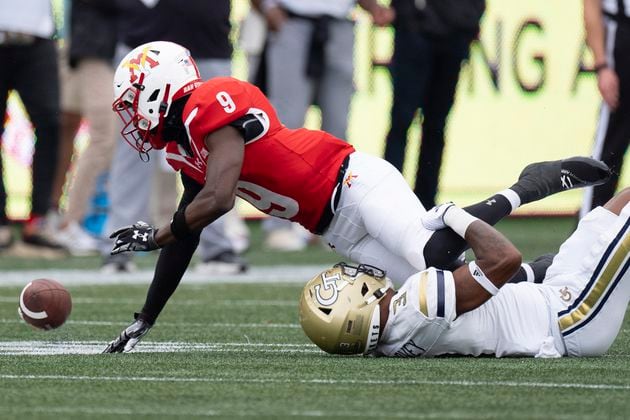 Virginia Military Institute wide receiver Julio DaSilva (9) fumbles after being hit by Georgia Tech defensive back Ahmari Harvey (3) during the first half of a NCAA college football game Sunday, Sept. 14, 2024, in Atlanta,. (AP Photo/John Bazemore)