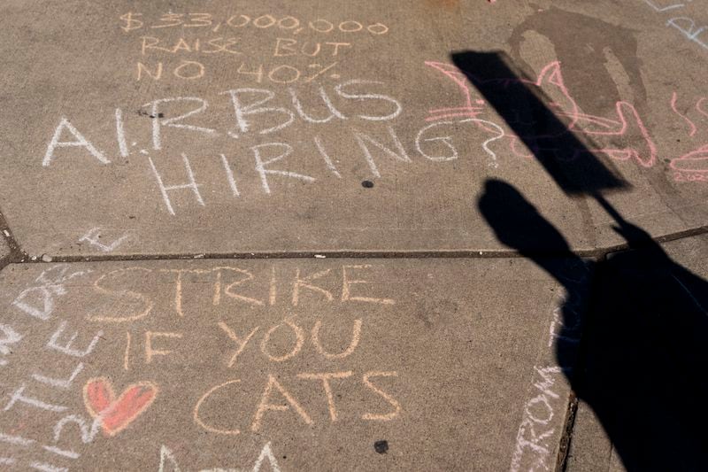 Messages written in chalk adorn the sidewalks outside of Boeing's Renton factory as employees continue to strike Tuesday, Sept. 24, 2024, in Renton, Wash. (AP Photo/Lindsey Wasson)