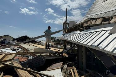 Hud Lilliott surveys what's left of his home after Hurricane Helene passed the area at Dekle Beach, Fla., in rural Taylor County on Friday, Sept. 27, 2024. (AP Photo/Kate Payne)