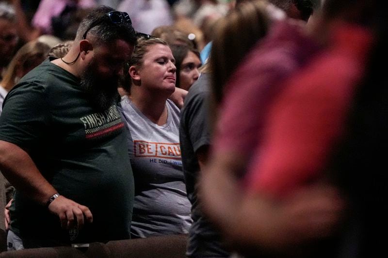 Church members pray during a Sunday service at Bethlehem Church, Sunday, Sept. 8, 2024, in Bethlehem, Ga. Colt Gray, 14, has been charged with murder over the killing of two students and two teachers at Apalachee High School in Barrow County, outside Atlanta, on Wednesday. (AP Photo/Mike Stewart)