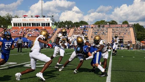 LaGrange wide receiver Gryson Cockrell (6) is tackled by a host of Douglass defenders on a reception during the first half in the Corky Kell Dave Hunter Classic at Kell High School, Wednesday, August 14, 2024, in Marietta, Ga. (Jason Getz / AJC)
