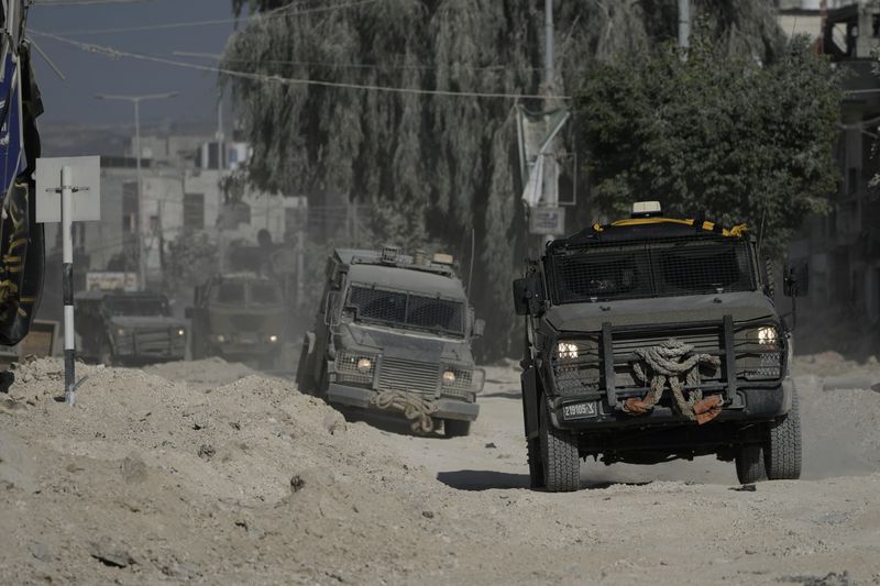 Israeli armoured vehicles move on a street during a military operation in the West Bank refugee camp of Nur Shams, Tulkarem, Thursday, Aug. 29, 2024. (AP Photo/Majdi Mohammed)