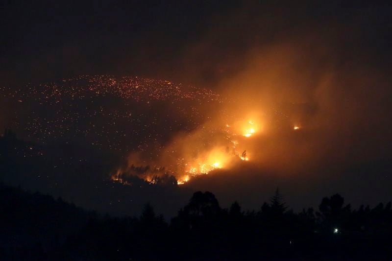 A fire burns on a hillside near Sever do Vouga, a town in northern Portugal that has been surrounded by forest fires, Tuesday, Sept. 17, 2024. (AP Photo/Bruno Fonseca)