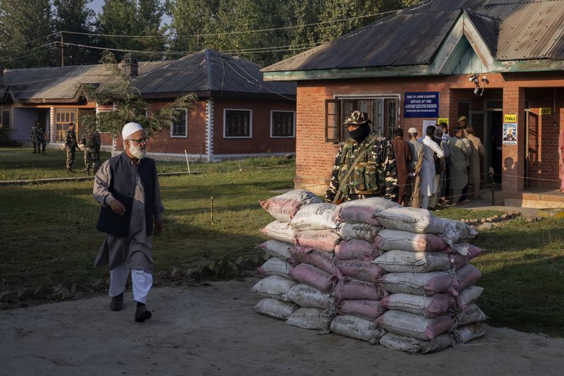 A Kashmiri man walks back after casting his vote at a polling booth in Marval, south of Srinagar, Indian controlled Kashmir, Wednesday, Sept.18, 2024. (AP Photo/Dar Yasin)