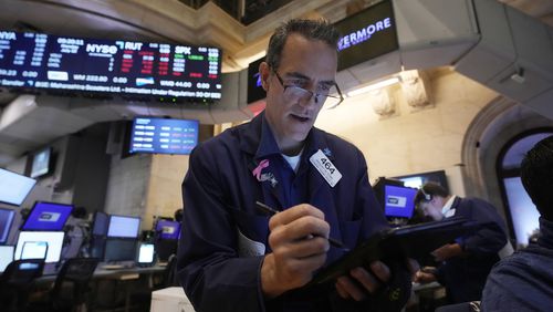 Trader Gregory Rowe works on the floor of the New York Stock Exchange, Monday, July 22, 2024. U.S. stocks are climbing Monday and clawing back some of the losses from their worst week since April. (AP Photo/Richard Drew)