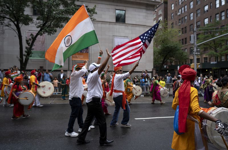 FILE - Participants march during the India Day Parade on Madison Ave. Sunday, Aug. 19, 2018, in New York. (AP Photo/Craig Ruttle, File)