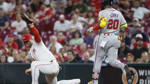 Cincinnati Reds first baseman Ty France, left, gets Atlanta Braves' Marcell Ozuna out at first base during the sixth inning of a baseball game, Tuesday, Sept. 17, 2024, in Cincinnati. The Braves lost 6-5. (AP Photo/Jay LaPrete)