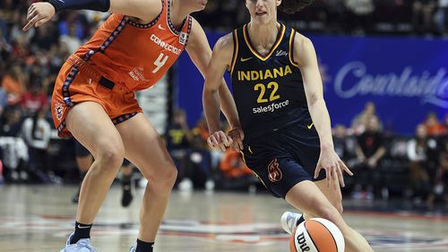 Connecticut Sun's Marina Mabrey (4) guards against Indiana Fever's Caitlin Clark (22) during a first-round WNBA basketball playoff game at Mohegan Sun Arena, Sunday, Sept. 22, 2024. (Sarah Gordon/The Day via AP)