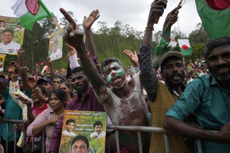 Tea plantation workers cheer for their political leaders during a presidential election rally in Thalawakele, Sri Lanka, Sunday, Sept. 8, 2024. (AP Photo/Eranga Jayawardena)