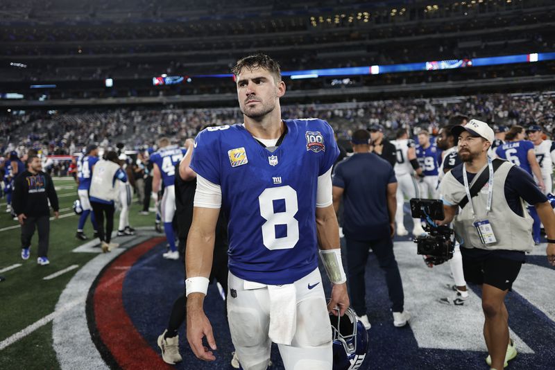 New York Giants quarterback Daniel Jones (8) walks off the field after playing against the Dallas Cowboys in an NFL football game, Thursday, Sept. 26, 2024, in East Rutherford, N.J. (AP Photo/Adam Hunger)