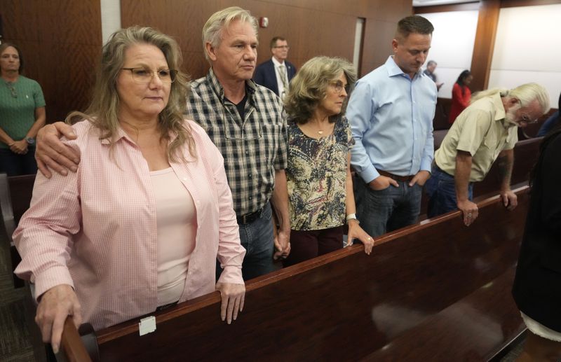 Family members of the late Dennis Tuttle wait for the jury to come into court for the verdict in murder trial of former Houston police officer Gerald Goines for the January 2019 deaths of Tuttle and Rhogena Nicholas, in the 482nd District Court at the Harris County Criminal courthouse Wednesday, Sept. 25, 2024, in Houston. Tuttle's siblings, from left, sister, Elizabeth Ferrari, and brother, Ron Tuttle, Ron's wife, Kristy Tuttle, Ryan Tuttle, son of Dennis Tuttle, and family friend Kenneth Ledbetter. (Melissa Phillip/Houston Chronicle via AP, Pool)