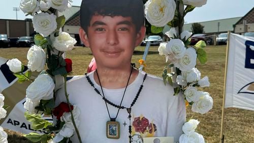 A poster with an image of shooting victim Christian Angulo is displayed at a memorial outside Apalachee High School, Tuesday, Sept. 10, 2024, in Winder, Ga. (AP Photo/Charlotte Kramon)