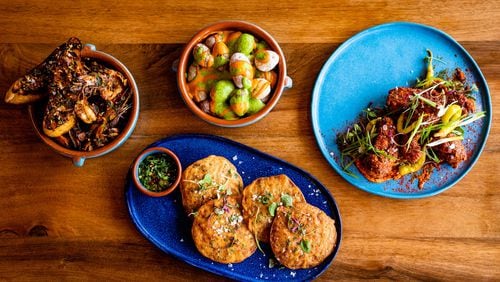 Buena Vida serves up plenty of tapas, including (clockwise from upper left): Gambas al Ajillo, Canary Island Wrinkly Potatoes, Crispy Pimentón Chicken and Torticas de Camaron. CONTRIBUTED BY HENRI HOLLIS
