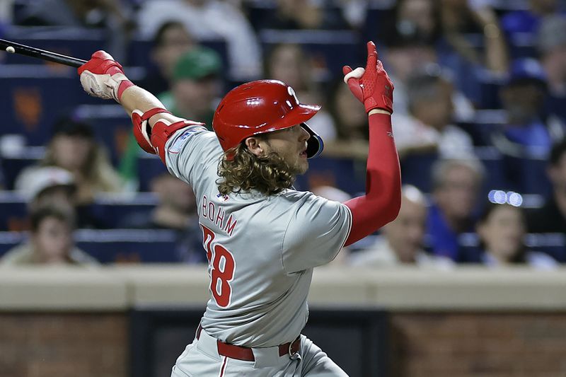 Philadelphia Phillies' Alec Bohm hits a three-run home run during the fourth inning of a baseball game against the New York Mets Friday, Sept. 20, 2024, in New York. (AP Photo/Adam Hunger)