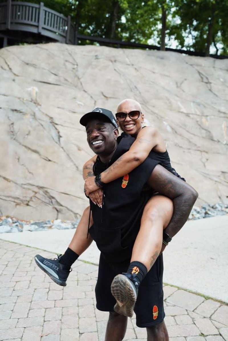 Rashad "Big Bank" Holsey carries his wife Shawnte during a hike.