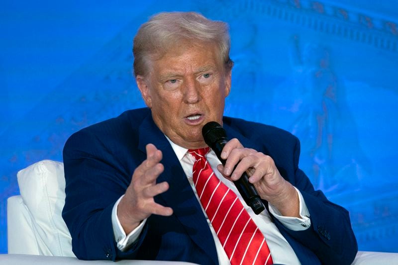 Republican presidential nominee former President Donald Trump speaks with Moms for Liberty co-founder Tiffany Justice during an event at the group's annual convention in Washington, Friday, Aug. 30, 2024. (AP Photo/Jose Luis Magana)